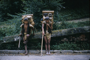 Porters rest while carrying goods to market