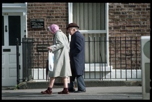 Older man and woman walking down Pembroke Road, Dublin, across from the U.S. embassy