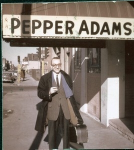 Pepper Adams, with saxophone in a case, posed beneath his name on the marquee at Connolly's Stardust Room
