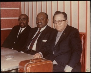 Bernie Moss, Ben Webster, and Yusef Lateef (from right) seated in a booth at the Jazz Workshop