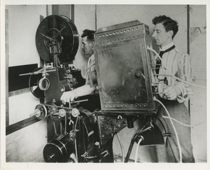Men operating film projector
