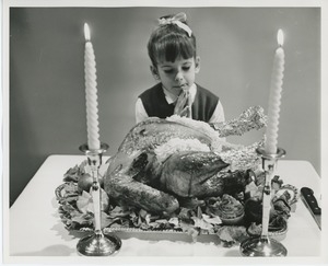 Young client praying with turkey