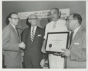 Orin Lehman presenting an award to Millard Hanenson, Inc.