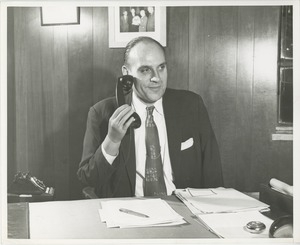 Unidentified man answering a phone with his prosthetic arm