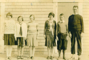 Students in front of the one-room schoolhouse