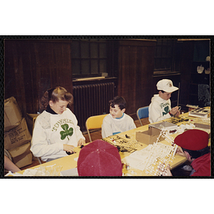 Several boys and a girl working on projects for their arts and crafts class at the Charlestown Boys and Girls Club