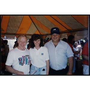 A runner poses with a woman and man during the Bunker Hill Road Race