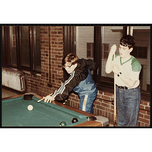 Two boys playing pool at an open house event