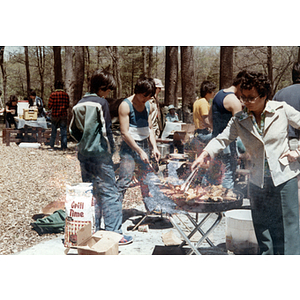 Woman grills food during a Chinese Progressive Association cookout