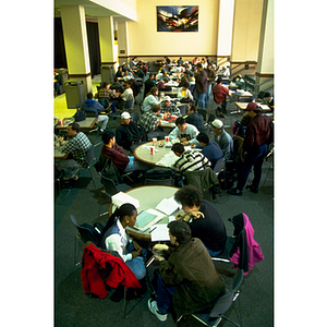 Students eating and studying at tables in the Curry Student Center