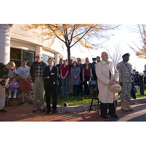 Several people watch the Veterans Memorial dedication ceremony