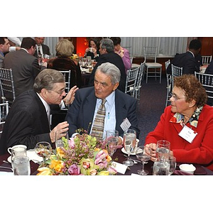 Eugene Reppucci sits with two others at The National Council Dinner