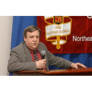 An unidentified speaker with a microphone at The National Council Dinner