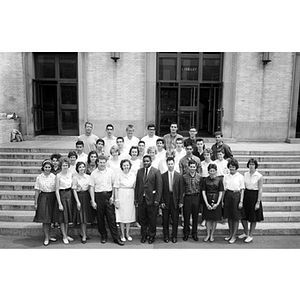 Professor Charles Goolsby poses with high school science students on the steps of Dodge Library