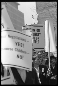 Antiwar protesters during the March on Washington carrying signs 'War on poverty, not on people'