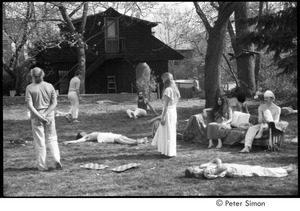 Ram Dass retreat at David McClelland's: group walking and laying on the grass in meditation, Ram Dass on the far left