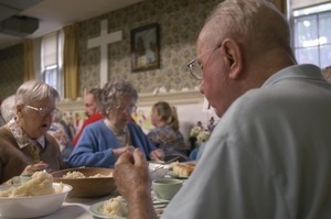 Church supper at the First Congregational Church, Whately: two women seated at a table, eating supper