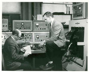 Thomas R. Stengle and unidentified man in a chemistry lab