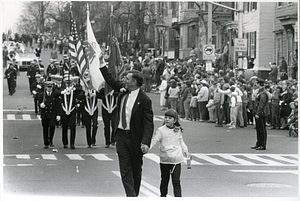 Mayor Raymond L. Flynn marching in South Boston's St. Patrick's/Evacuation Day parade with his daughter Katie