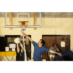 Man hitting a volleyball over a net