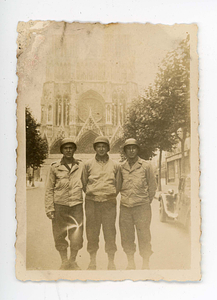 View of three soldiers in front of church