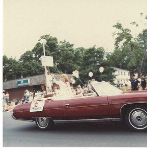 Peg Heckler riding in a convertible in the Town of Plainville 75th Anniversary Diamond Jubilee parade