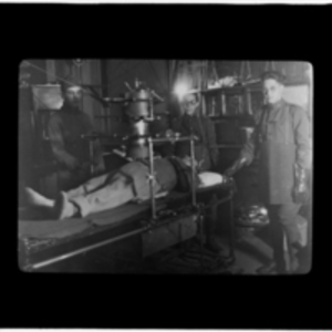 Patient being x-rayed by three technicians