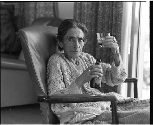 Margaret Barry, "Queen of the Gypsy Singers." Taken in Banbridge Hospital a few days before she died. Posed, sitting in a hospital chair with a bottle of Guinness in front of her ready to drink