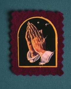 Badge of praying hands