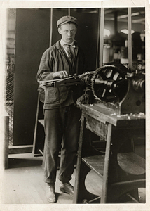 [Student working in the machine shop]