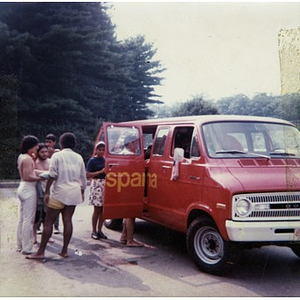 Group of two female and four male Latino youths get into La Alianza Hispana's red van after spending the afternoon at a park and lake, an outing sponsored by La Alianza Hispana.