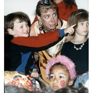 Woman surrounded by children in costume.