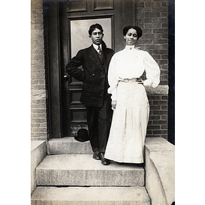 Couples photograph, man and woman standing on stoop