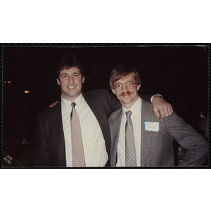 Jerry Steimel, at right, and an unidentified man posing for the camera with their arms around each other at a Boys' Club event