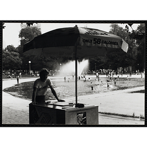 A teenage boy poses with his ice juice cart on Boston Common