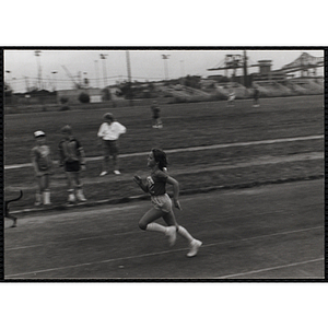 A child runs in a race on an outdoor track