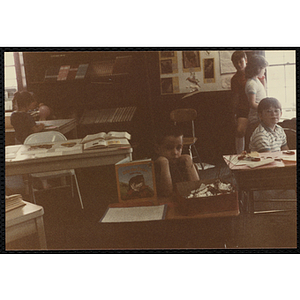 Students sitting and standing next to their science projects