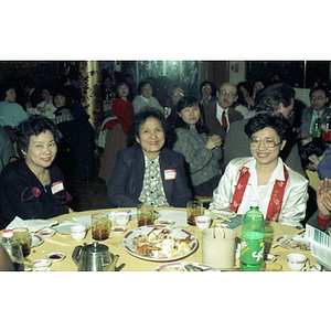 Suzanne Lee sits with two women during a celebration of the Chinese New Year held by the Chinese Progressive Association