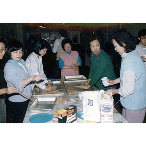 Women prepare food at Chinese Progressive Association's celebration of the Chinese New Year