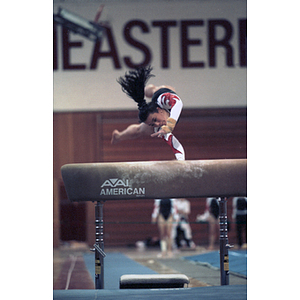 Female gymnist vaults over a horse during competition at Cabot Gym