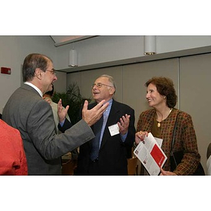 President Aoun and Sam Altschuler gesture in conversation at the Torch Scholars dinner