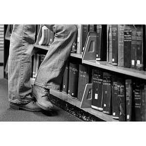 Person (only legs are visible) in the Dodge Library stacks