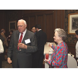 Attendees standing at bar at the gala dinner for John Hatsopoulos