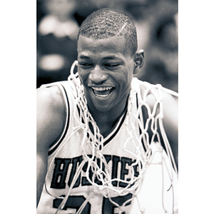 Reggie Lewis with a basketball net around his neck and shoulders