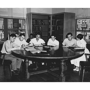 Students studying around a table in Dodge Library