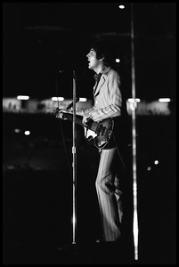 Paul McCartney (the Beatles) playing bass and singing in concert at D.C. Stadium: full-length portrait