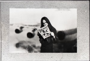 Heidi Bushell reading a copy of Free Spirit Press (vol. 1, 4) at the airport: manipulated copy print inserting background image of airport