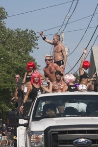 42 Below vodka float, with buff young men and women in skimpy outfits : Provincetown Carnival parade