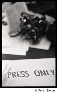 View of 'Press only' sign and camera equipment on a table