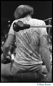 View from behind of Ram Dass on stage during an appearance at the College of Marin